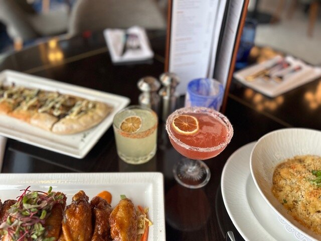 a table with plates of food and drinks