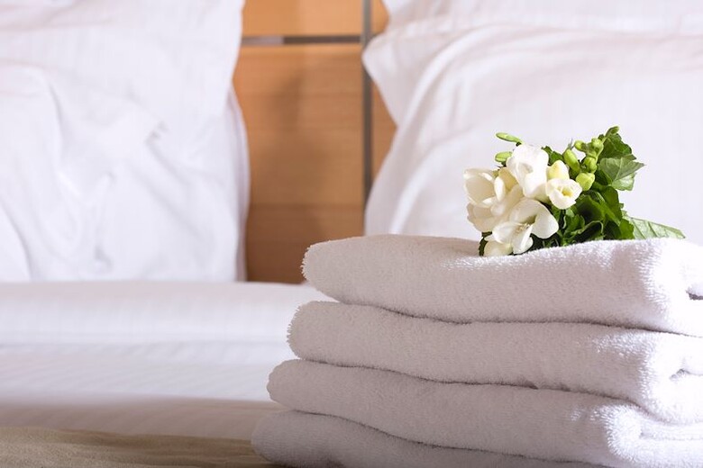 Fresh towels on clean bed at the Blu-tique Hotel